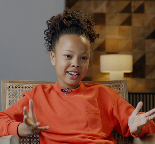 a girl sitting down talking